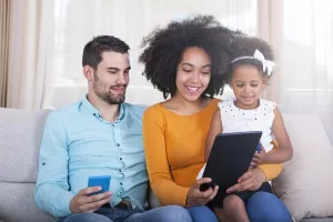 Family sitting around a computer