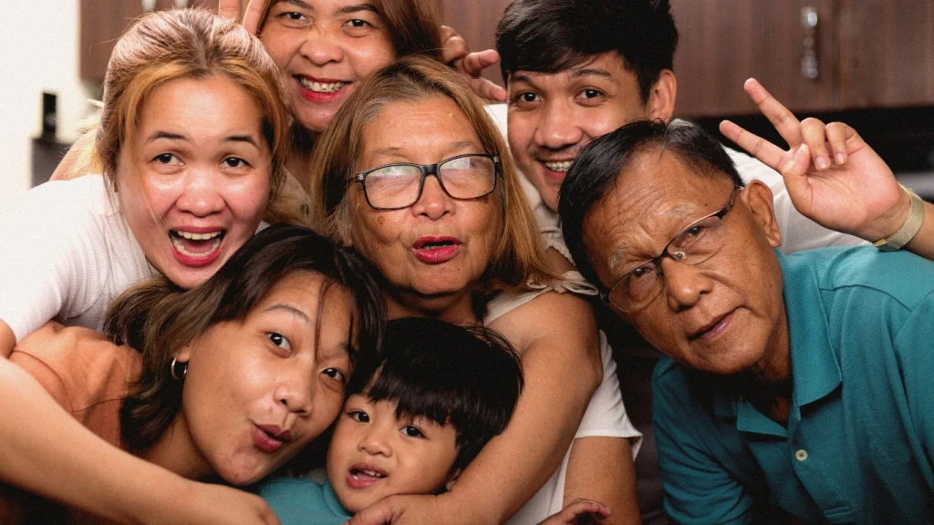 Multigenerational family group posing joyfully for a selfie – representing legacy protection through life insurance.