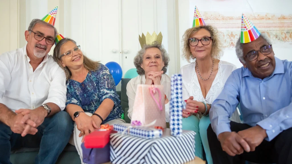 Happy senior friends celebrating a birthday — peace of mind with life insurance in retirement.