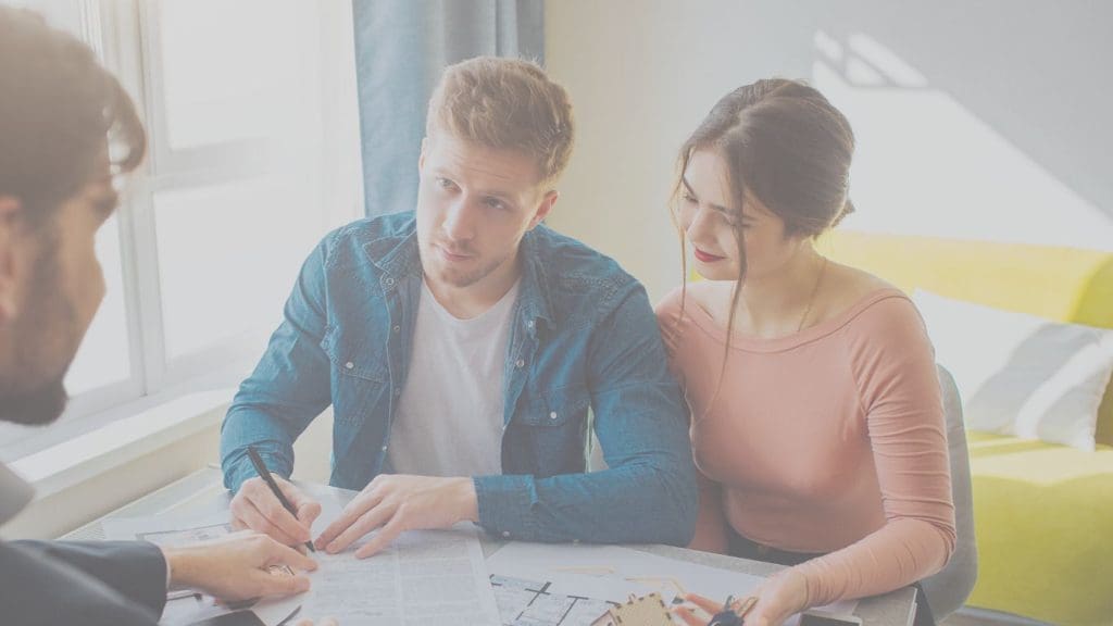Canadian couple reviewing mortgage life insurance options at their kitchen table