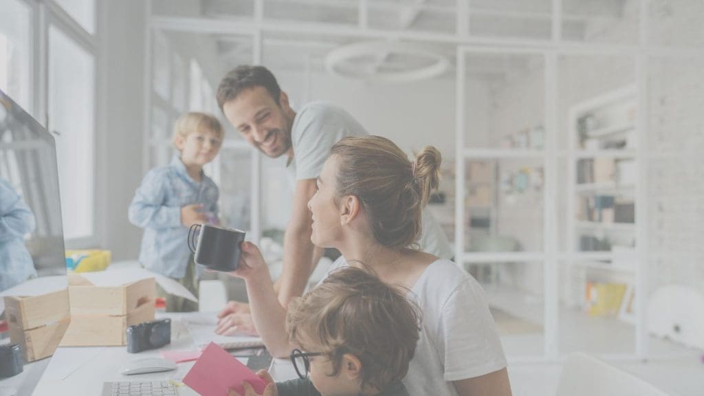 Young Canadian couple sitting at a kitchen table reviewing 20 year term life insurance options