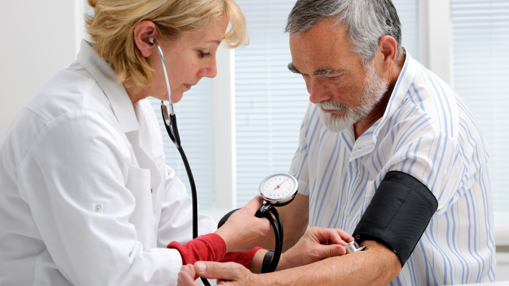 Female nurse checking a man's blood pressure for Life Insurance 30 Year Term