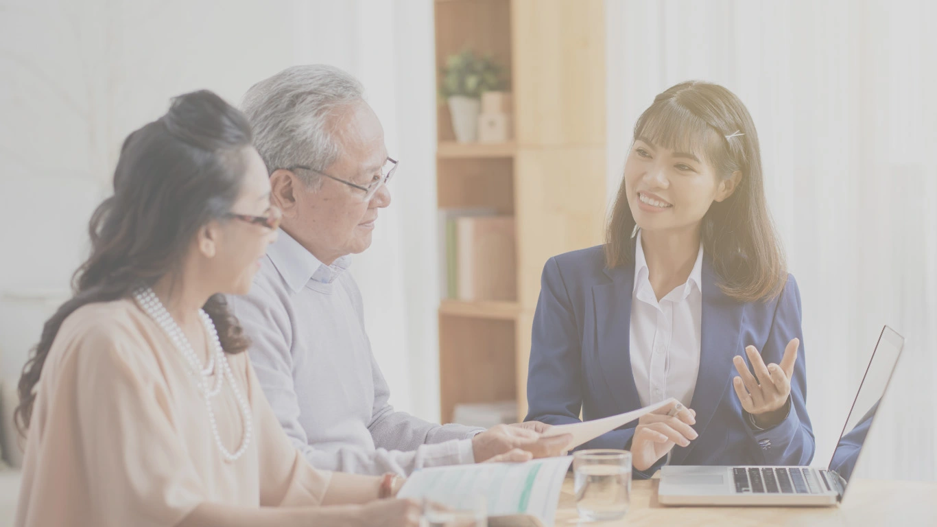 Life insurance advisor explaining term life policy to senior couple — retirement planning support