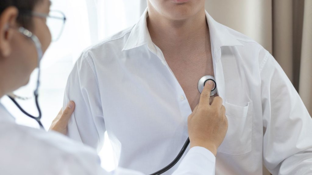 Canadian man completing a routine medical exam required for 30 year term life insurance coverage