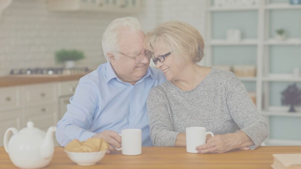 Older Canadian couple reviewing their Term 100 life insurance policy at home