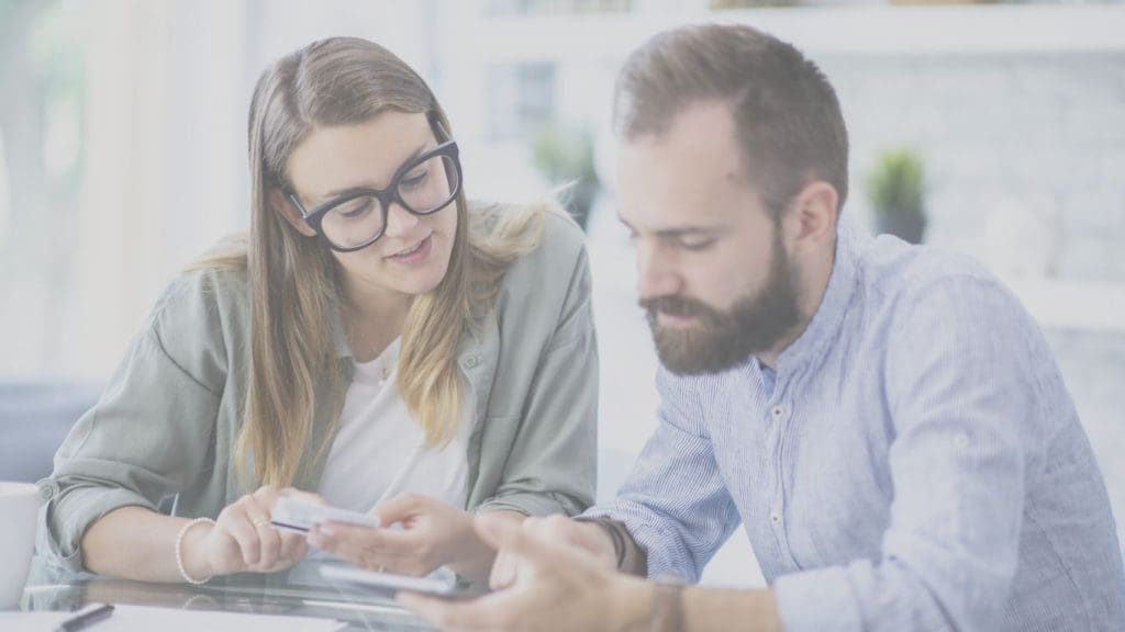 Young Canadian couple reviewing life insurance quotes online