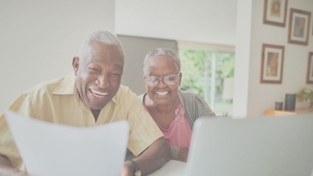 Senior Canadian couple reviewing joint life insurance policy at home