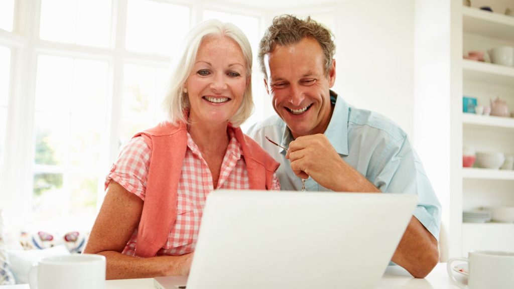 Canadian couple reviewing life insurance beneficiary forms at home